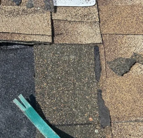 Herts crew replacing damaged shingles during a roof repair in Rahway NJ
