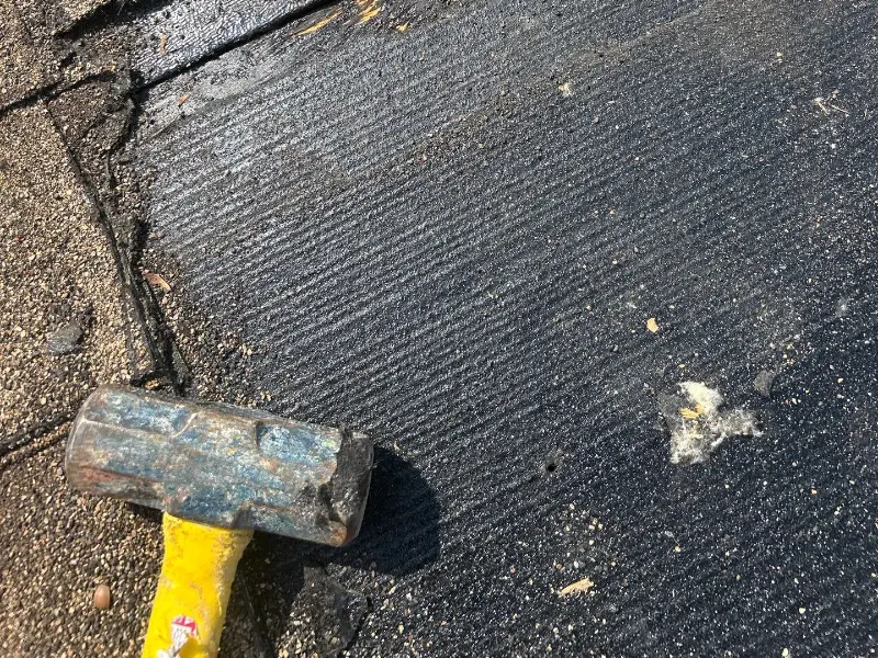Torn shingles and exposed underlayment found on a roof inspection in Rahway NJ