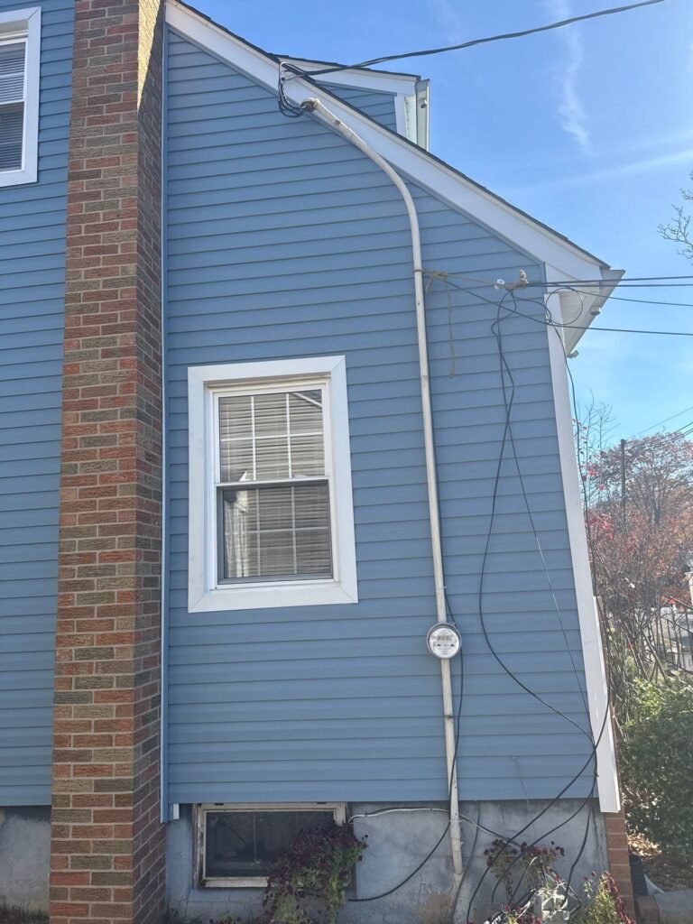 After: blue vinyl siding and white window trim on the chimney side of a Garwood NJ home