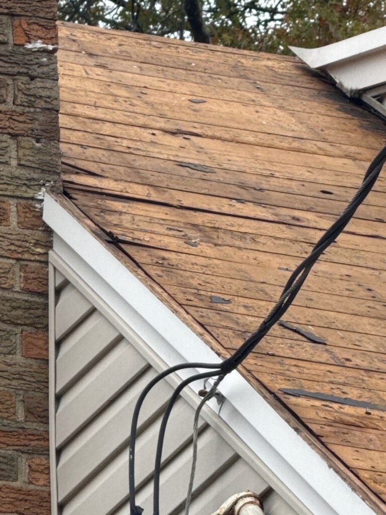 Old plank roof boards exposed after tearing off three layers of shingles in Garwood NJ