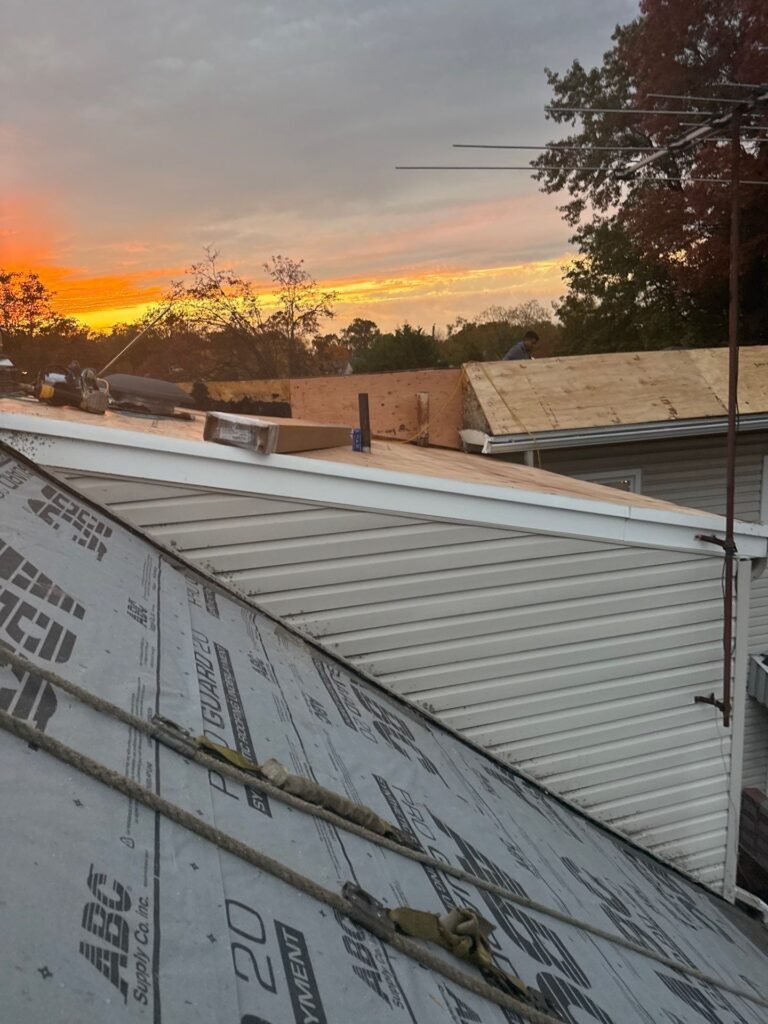 Synthetic underlayment going down at sunset on a roof replacement in Garwood NJ